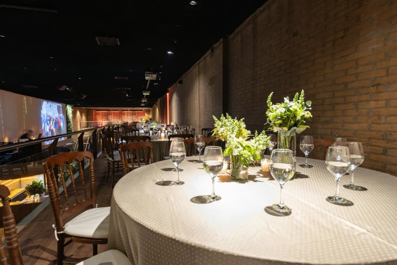 a dining table with white tables and chairs