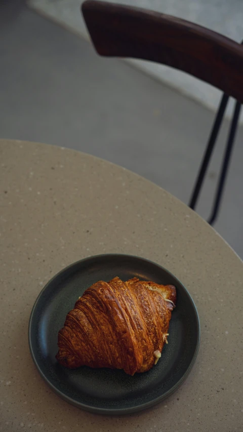 the pastry is on the plate near the table