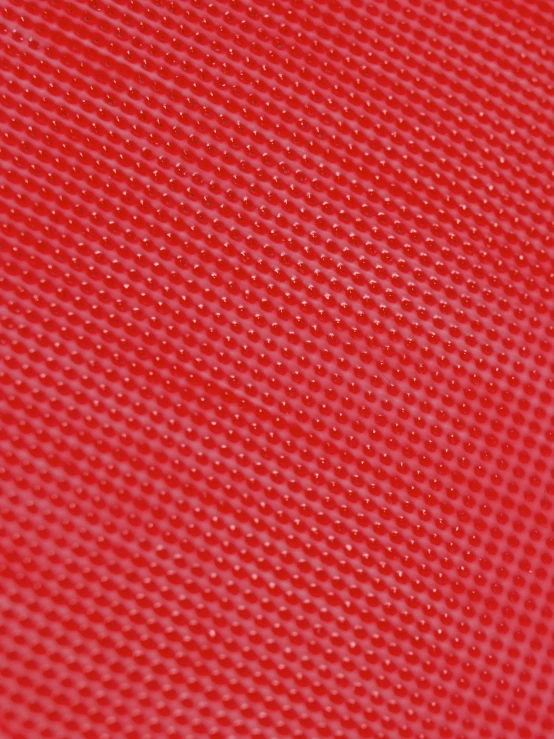 a red surface that has some white dots