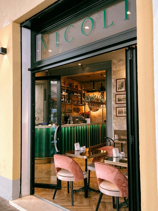 a person sitting at a table in front of a storefront