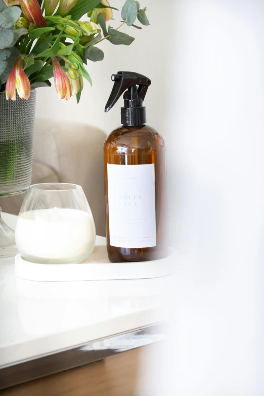 a bottle of liquid sitting on top of a white counter