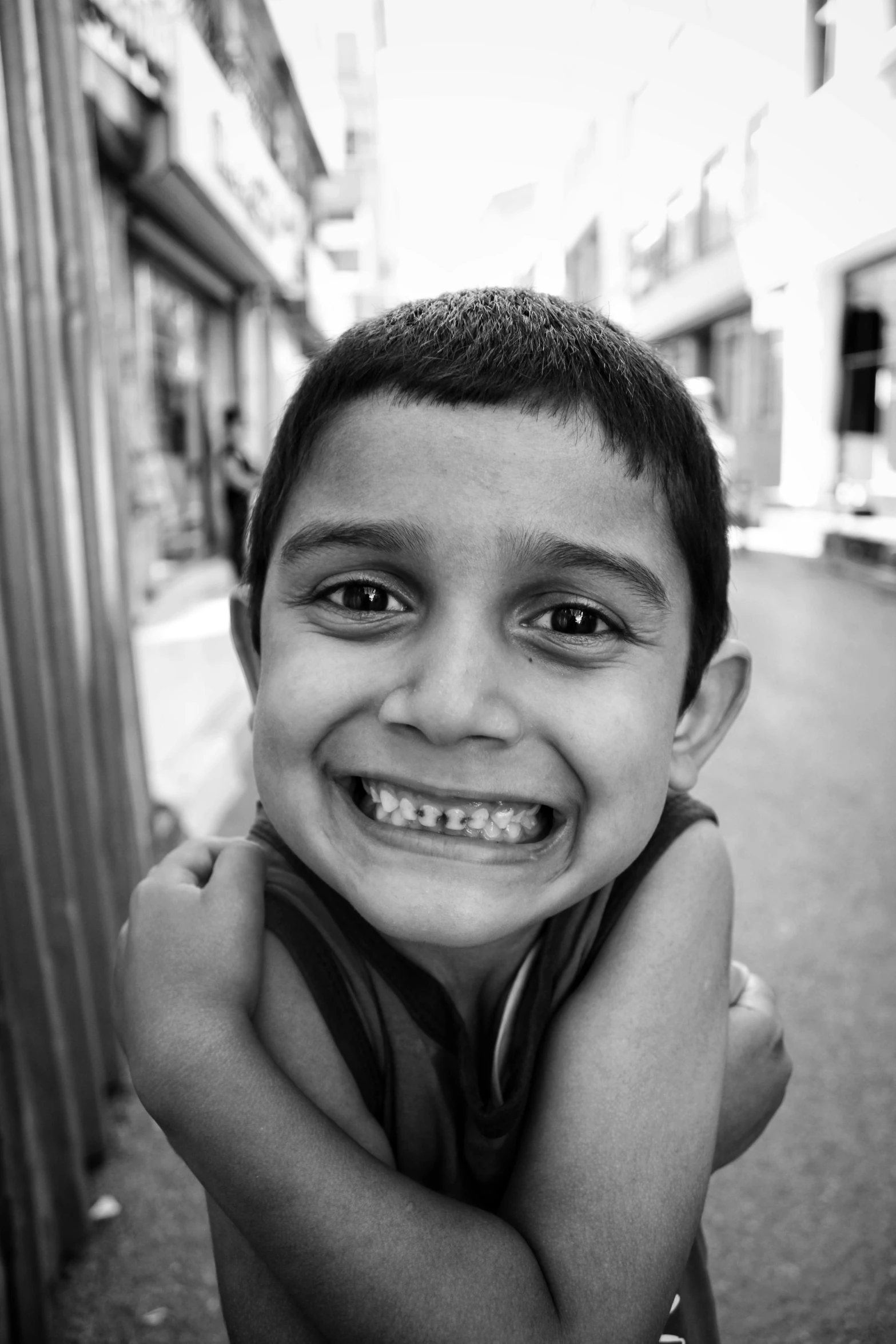 a black and white po of a little boy in the street