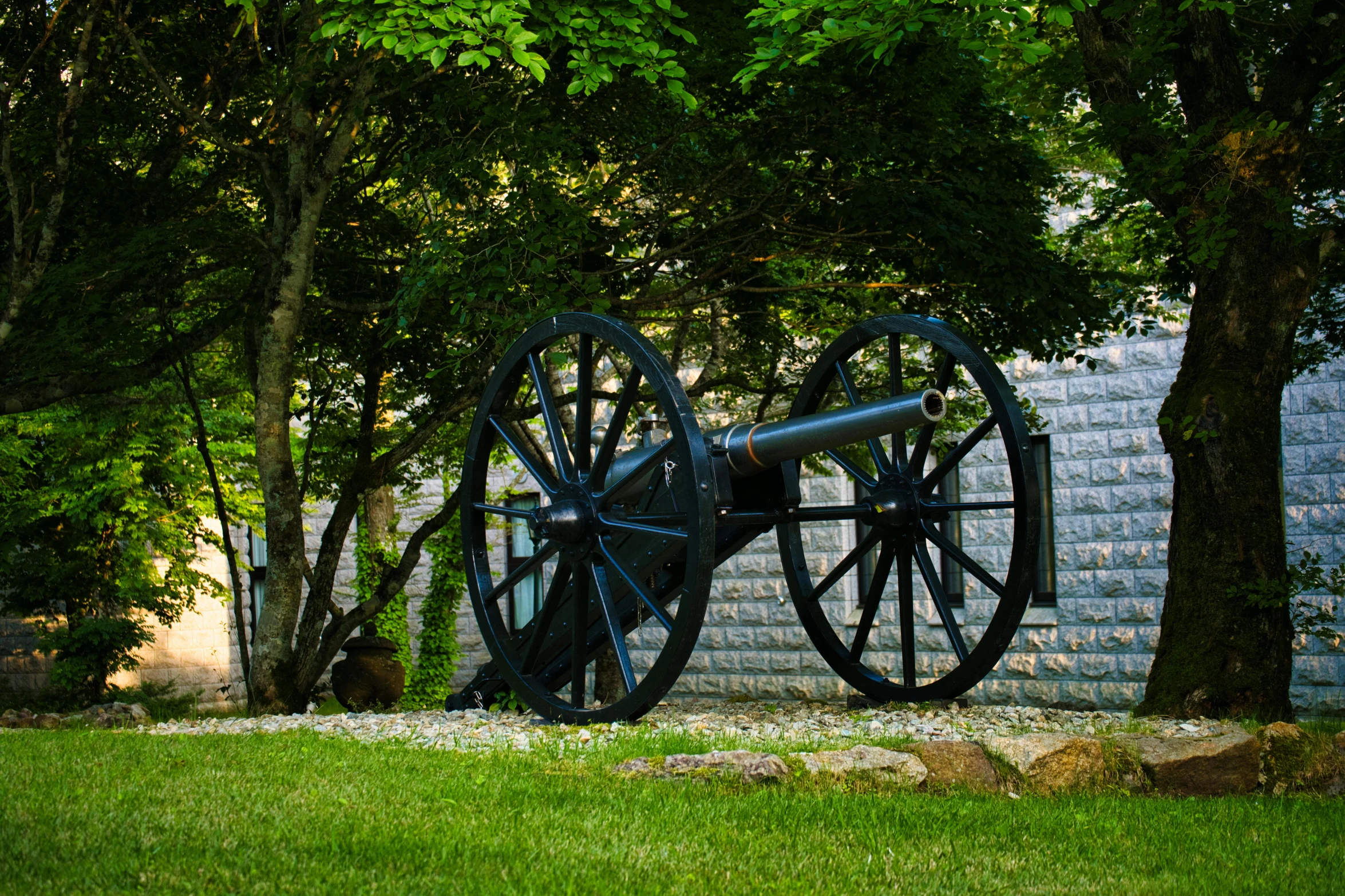 the cannon is on display near a wall