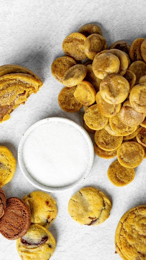 cookies and powdered sugar next to a cup of milk