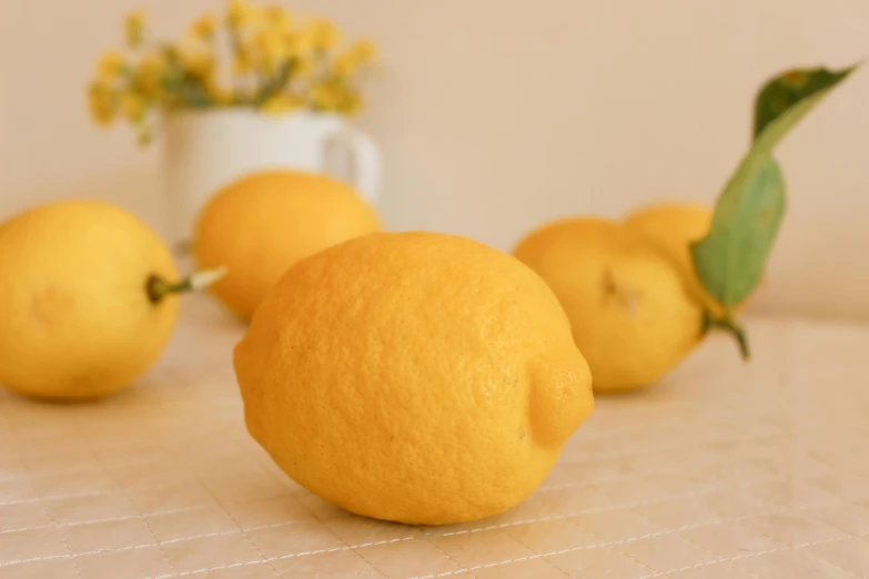 lemons and some flowers on a table