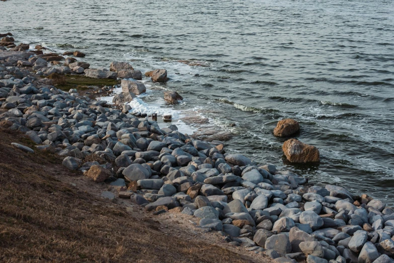 the rocky shore is lined with rocks