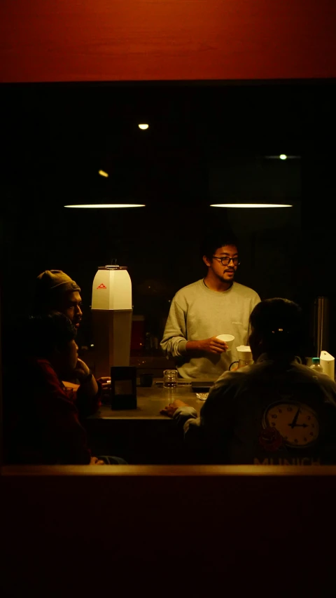 a man sitting at a table in a restaurant next to a woman