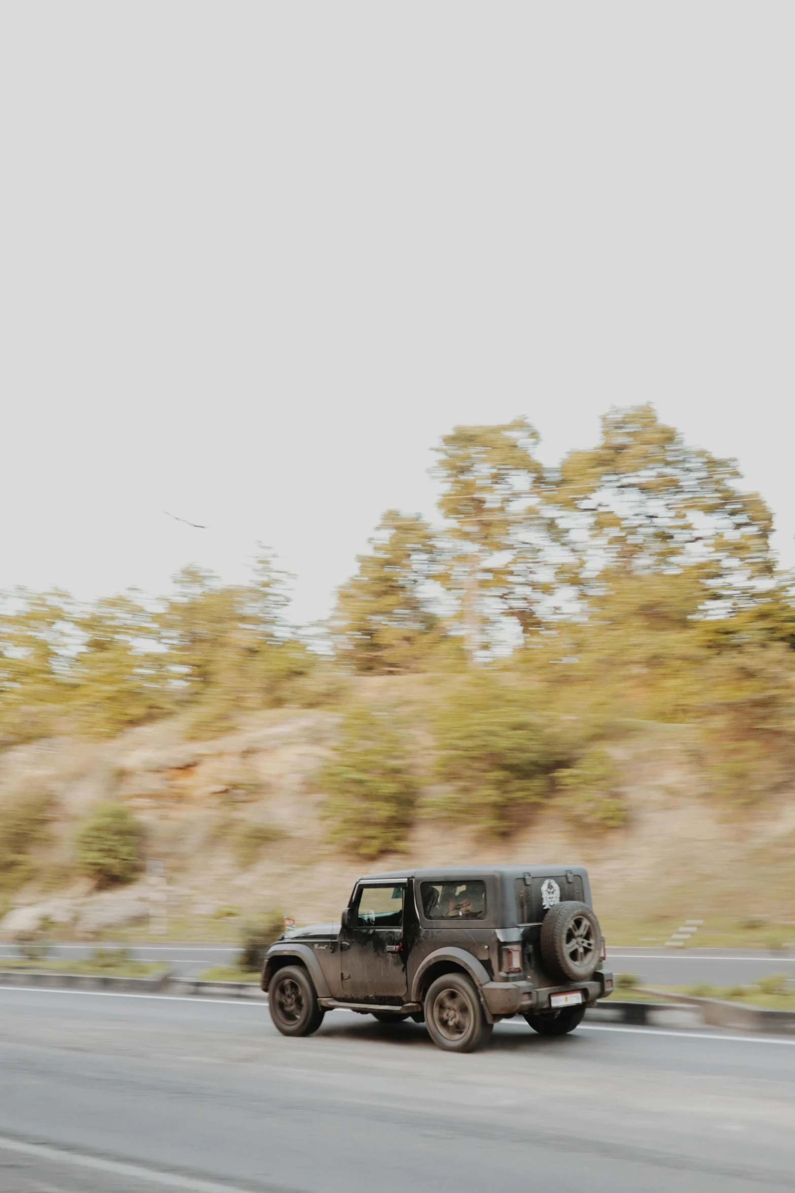 an old truck driving down the road