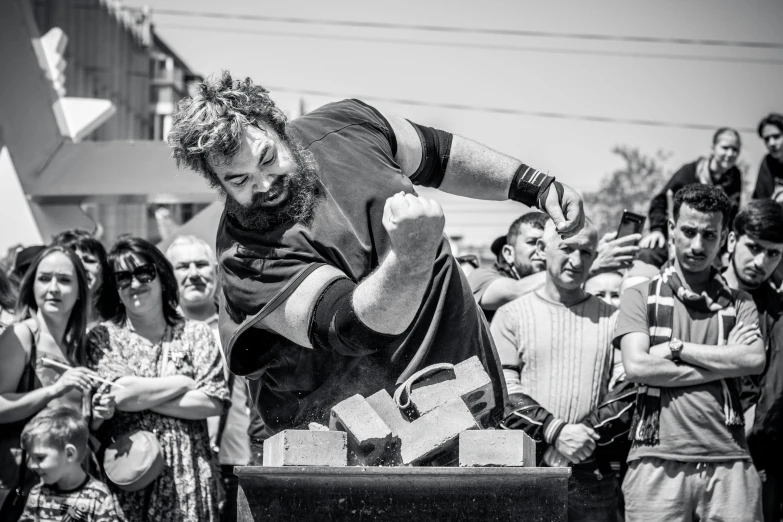 a crowd of people watch the person skateboard