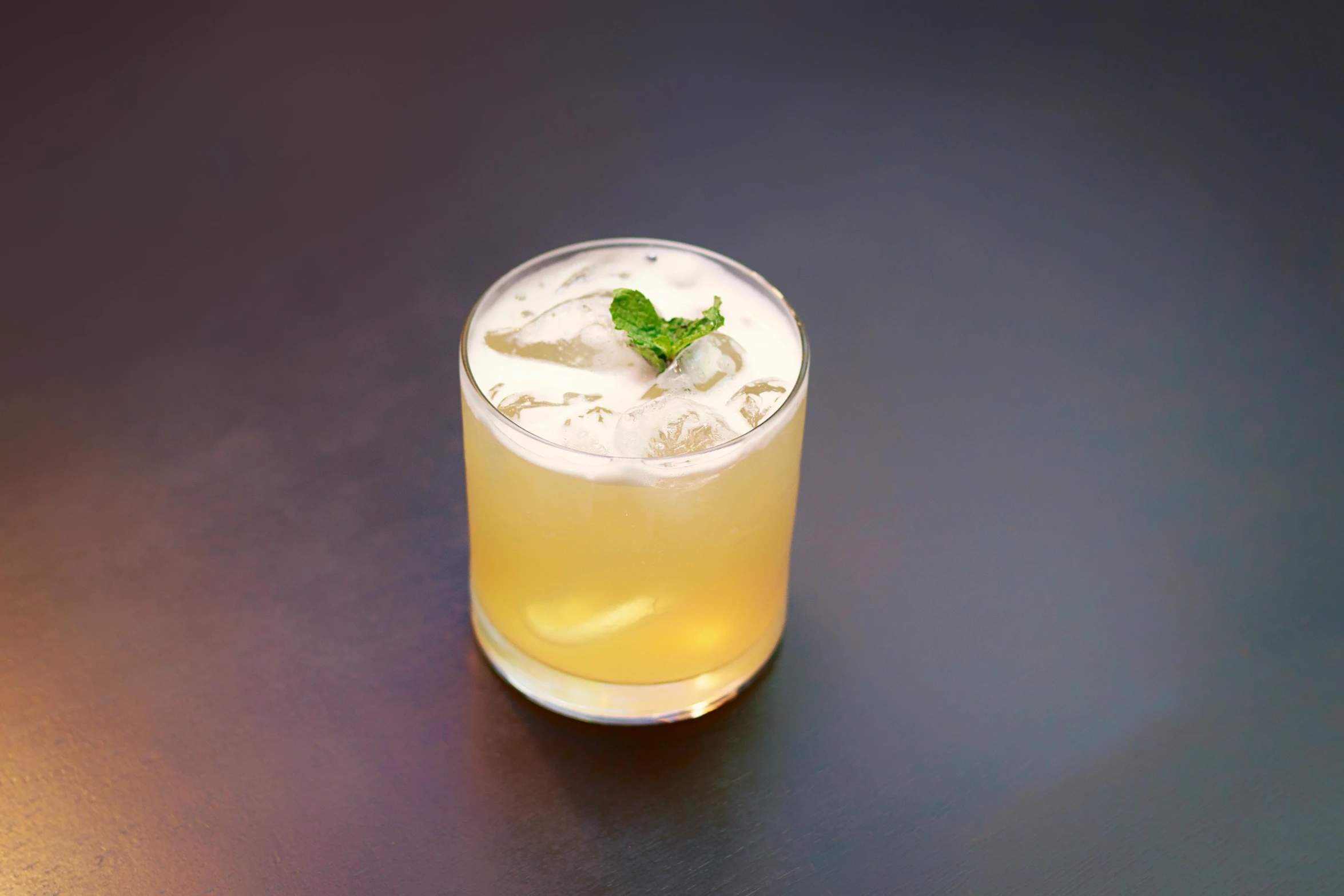 a drink with lime sitting on top of a counter