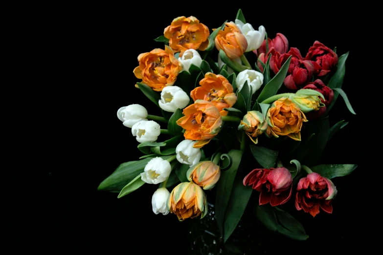 a bouquet of flowers is shown against a black background