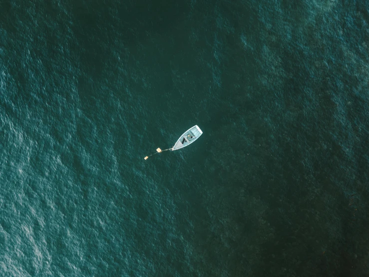 an aerial s of a sailing boat on the water