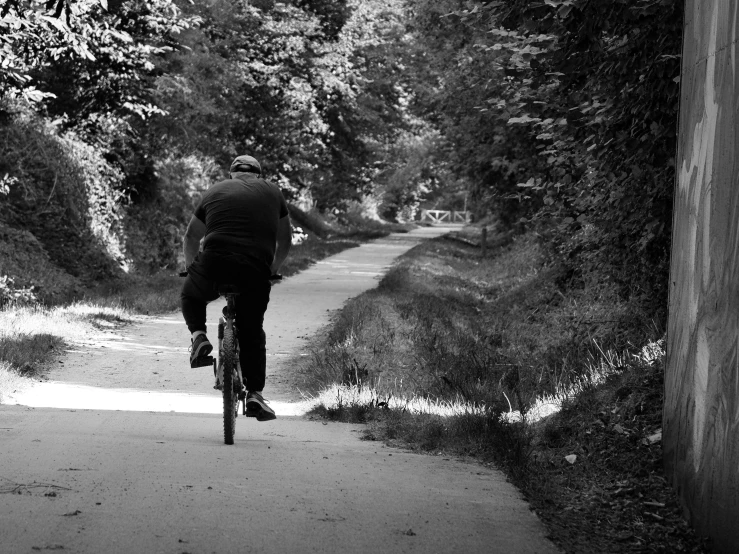 a black and white po of a man on a bike