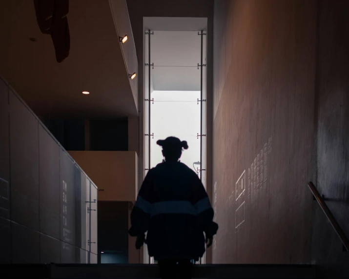 an empty hallway with a person walking on the floor