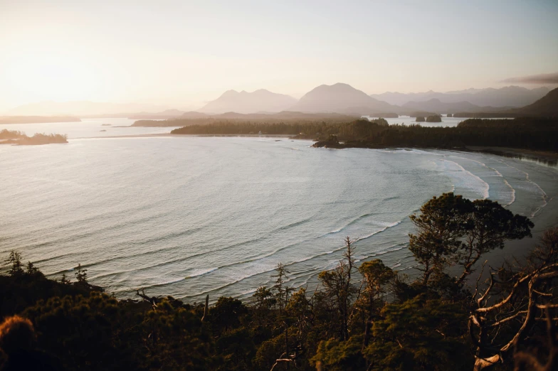 a large body of water sitting below mountains