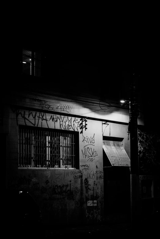 black and white pograph of the outside of a building that has graffiti all over it