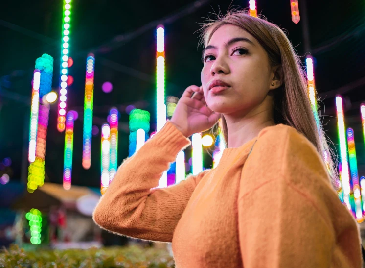 a woman talking on her phone at a brightly lit event