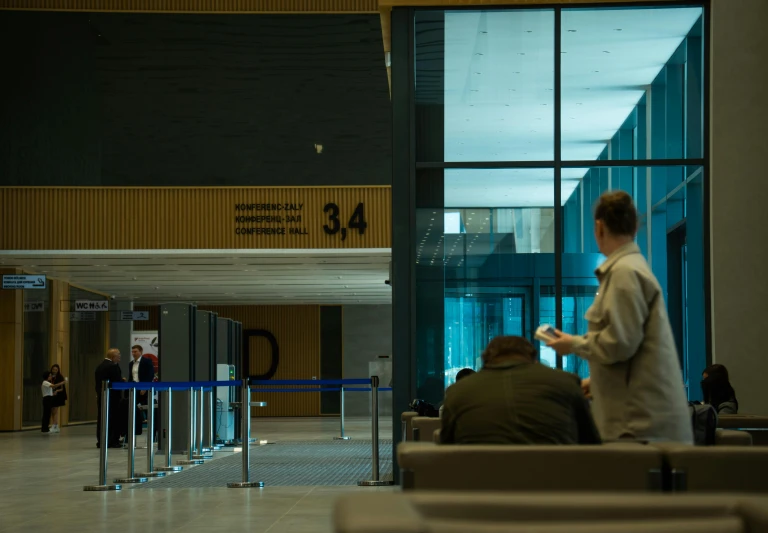 a man is standing by a gate at an airport