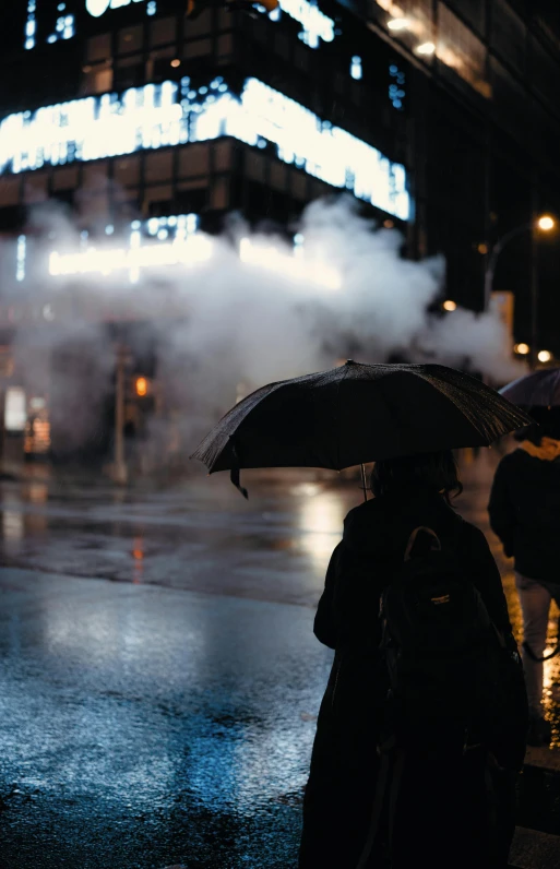 two people standing on the sidewalk in the rain with umbrellas