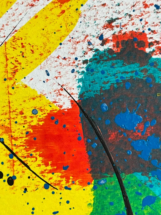 colorful paint on a surface is painted with white and red colors