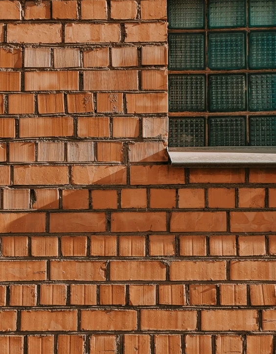 a black and white fire hydrant on the side of a brick wall