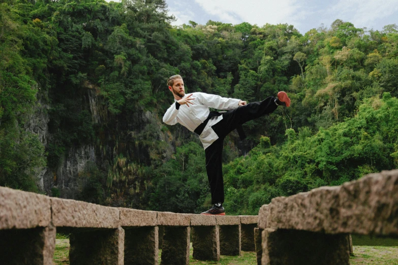 a man standing on one leg and doing a trick