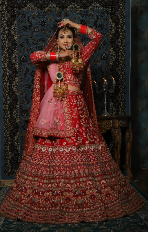 a young woman standing in a red bridal