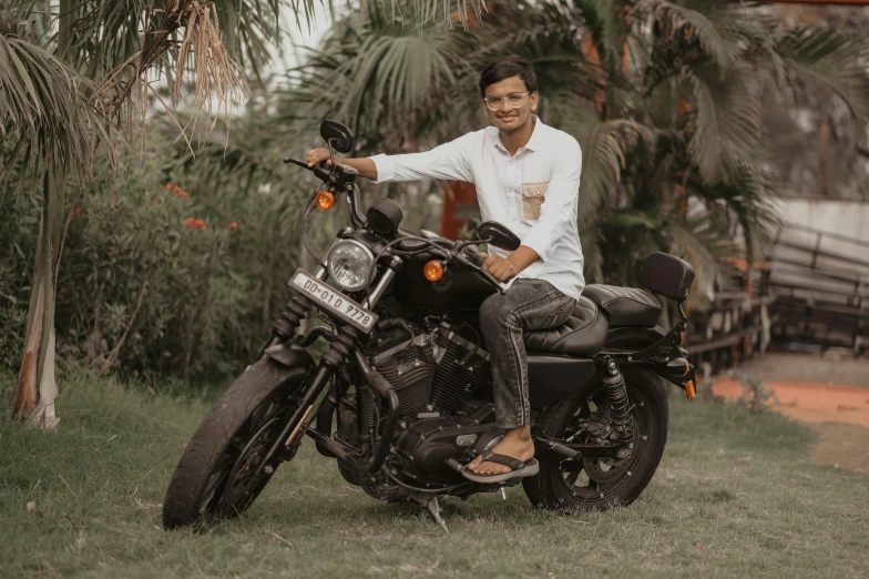 man in white shirt sitting on black motorcycle