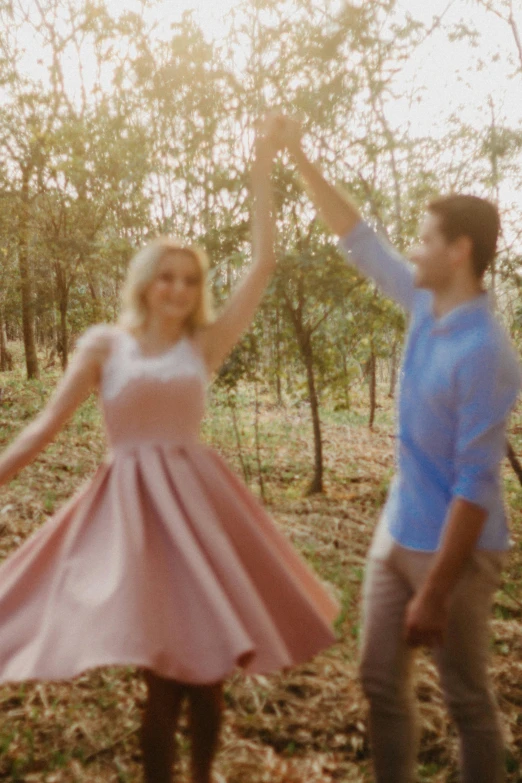 an image of two people dancing in the woods