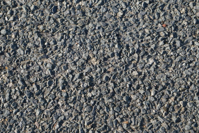 a stone surface is made up with dark rocks