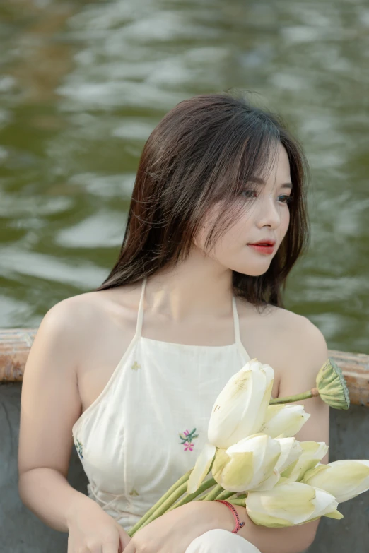 the girl is holding a bouquet of flowers