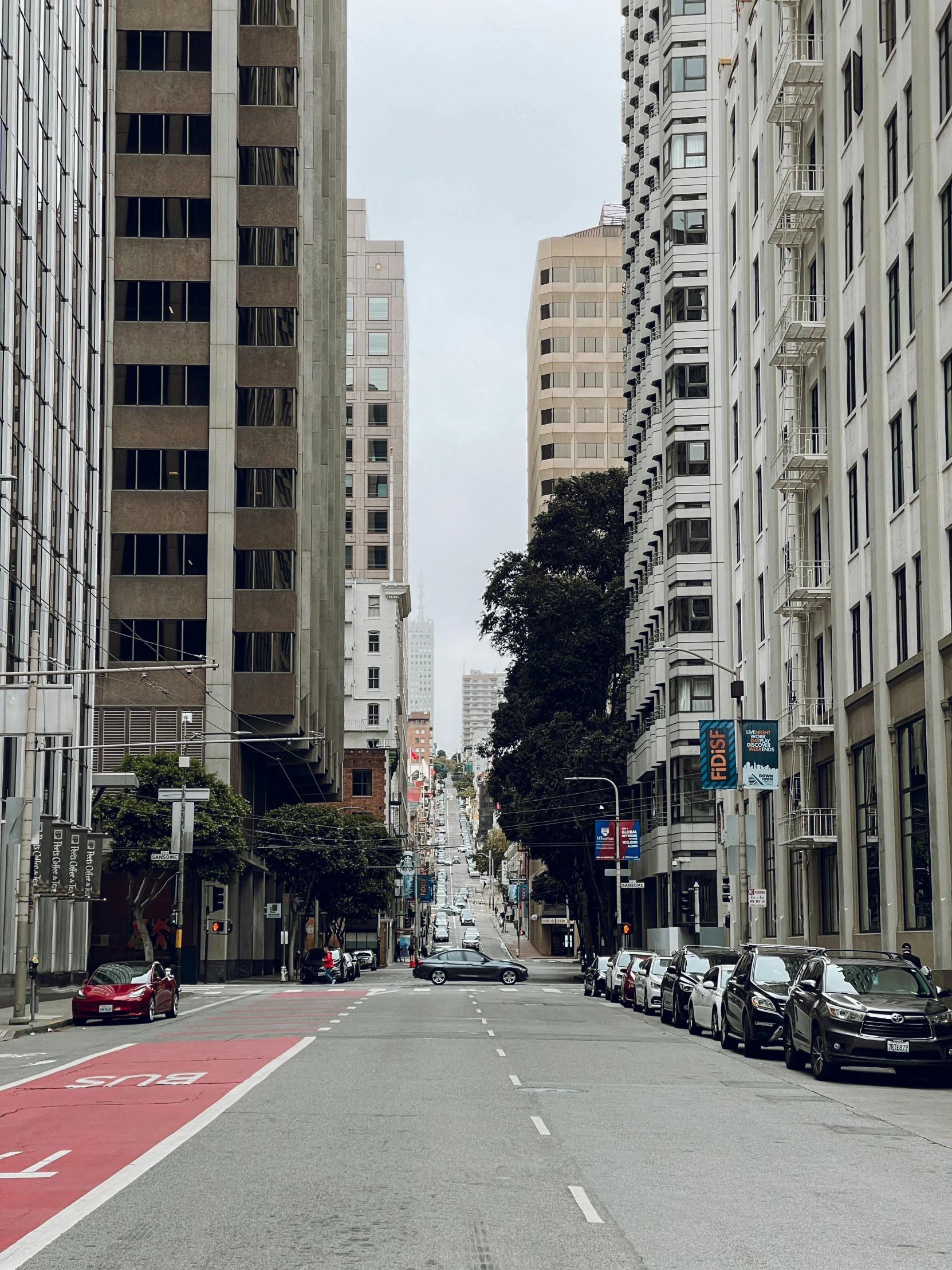 an empty street in front of many tall buildings