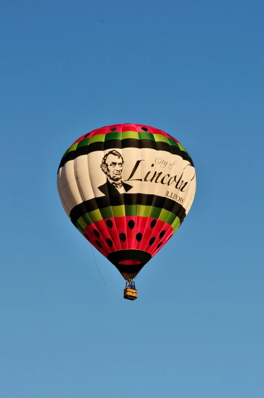 large  air balloon flying through a blue sky
