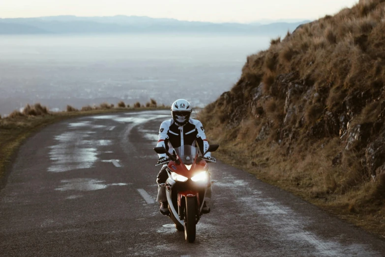 a person is riding on a motorcycle down the road