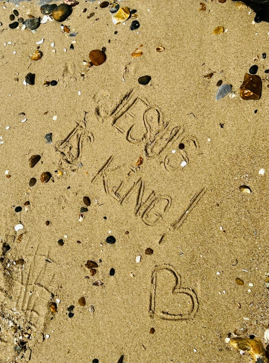 footprints left on the beach with hearts on it