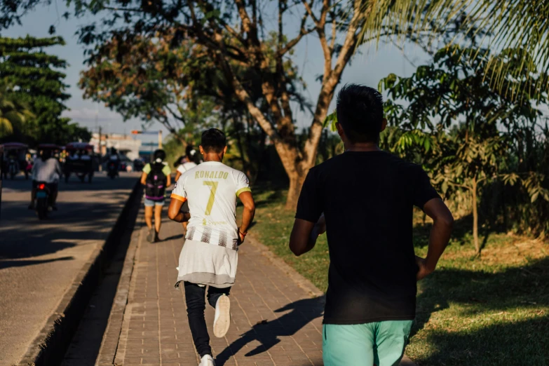 the man and woman are walking together down the sidewalk