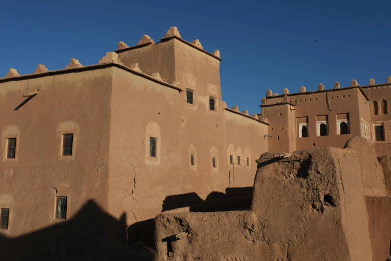 an adobe styled house with large steps and windows