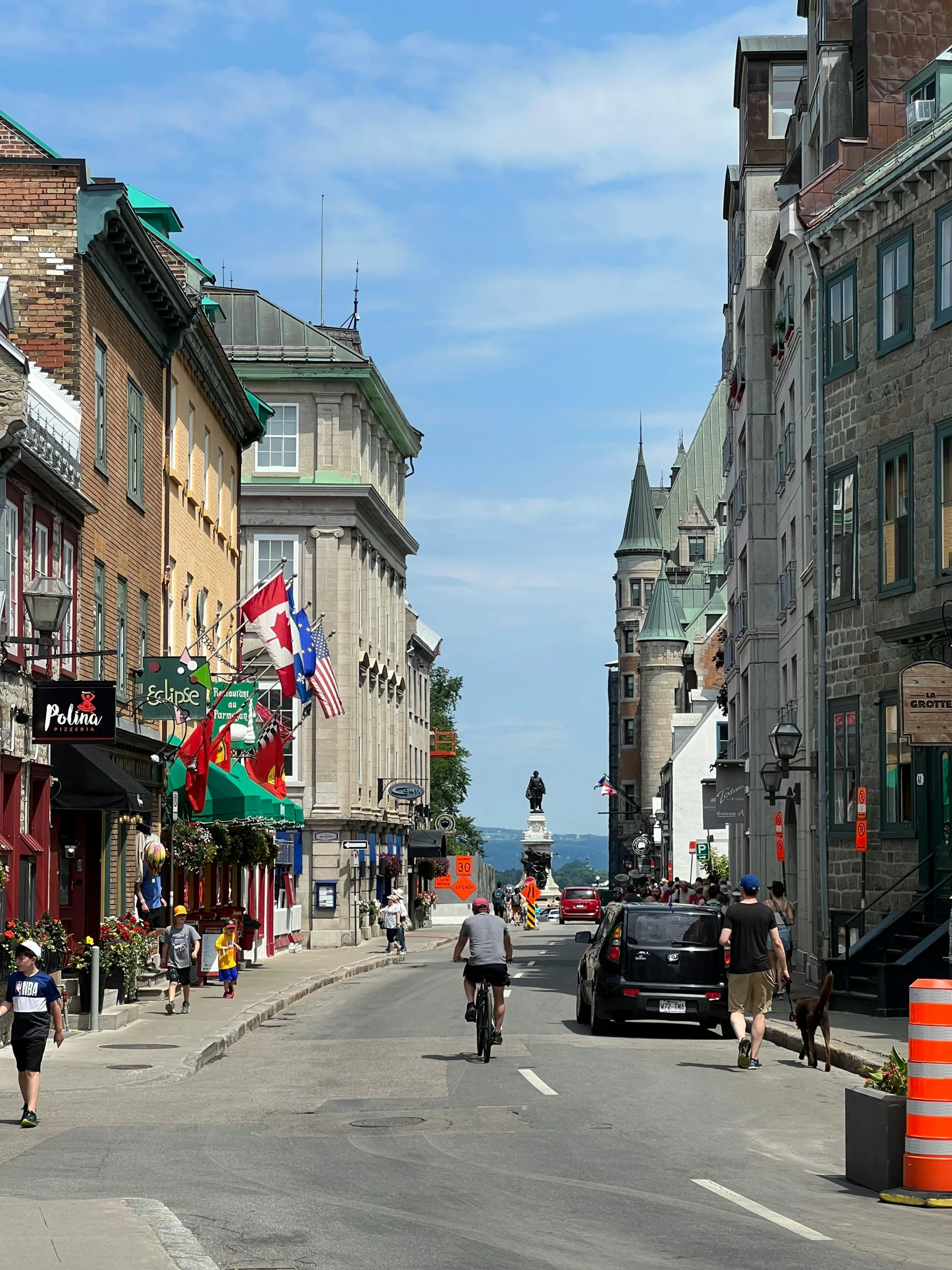 a street filled with pedestrians and parked cars