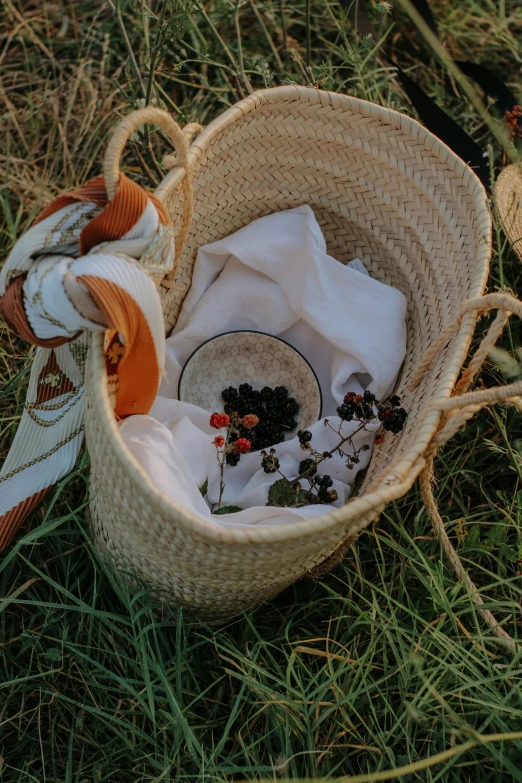 a basket with items and cloth on the ground