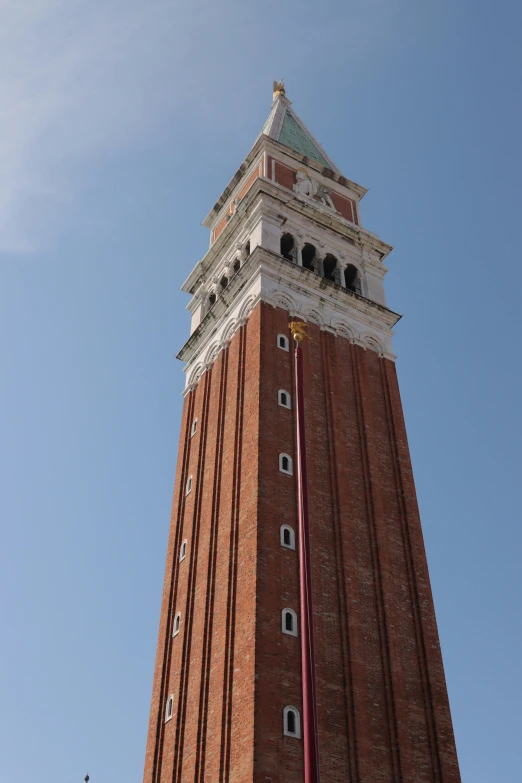 a tall brick building with a clock at the top of it
