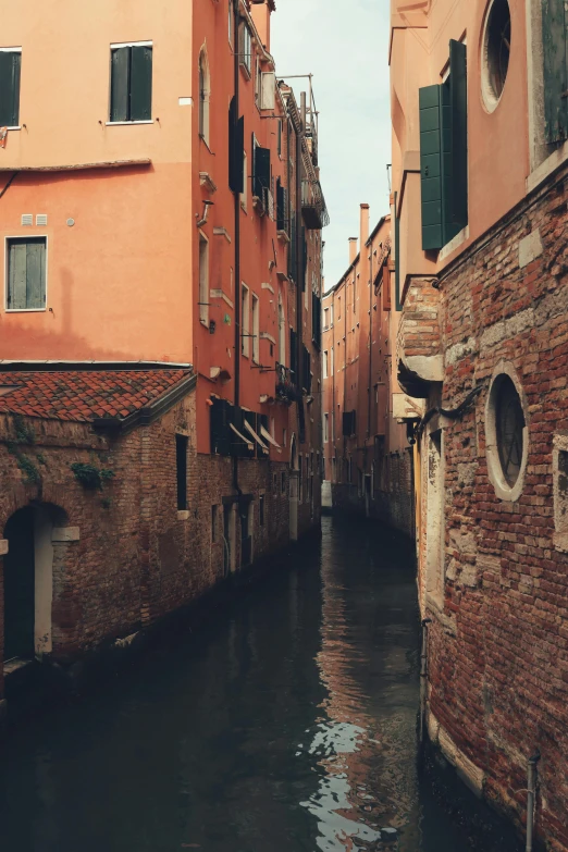 an alley between two buildings and water