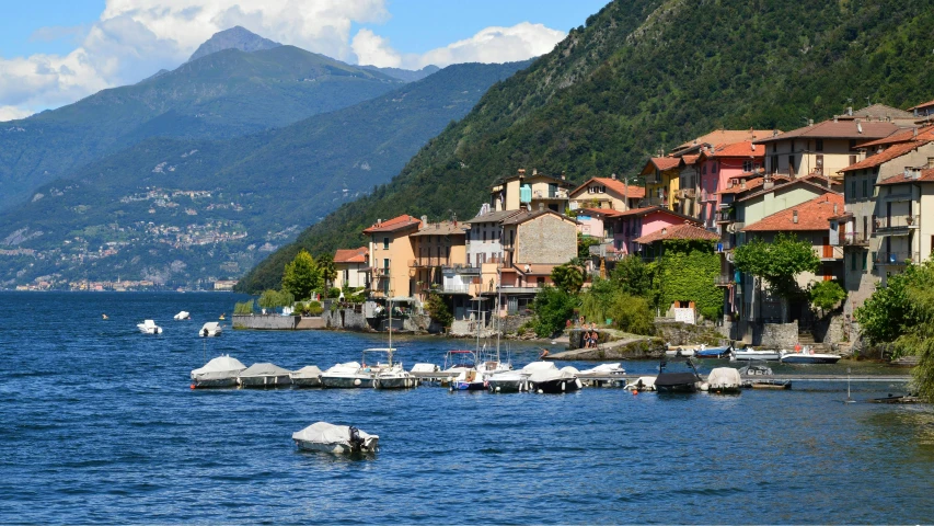 a lake with a city next to it and mountains