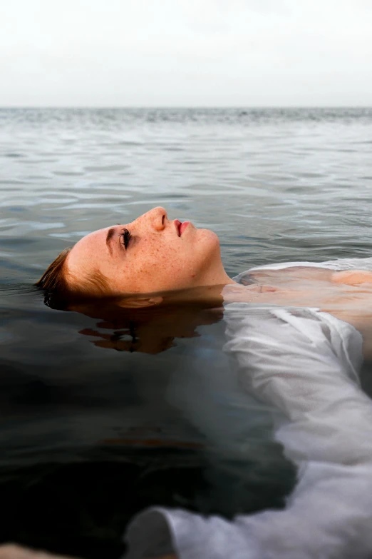 woman swimming in ocean and head submerged in water