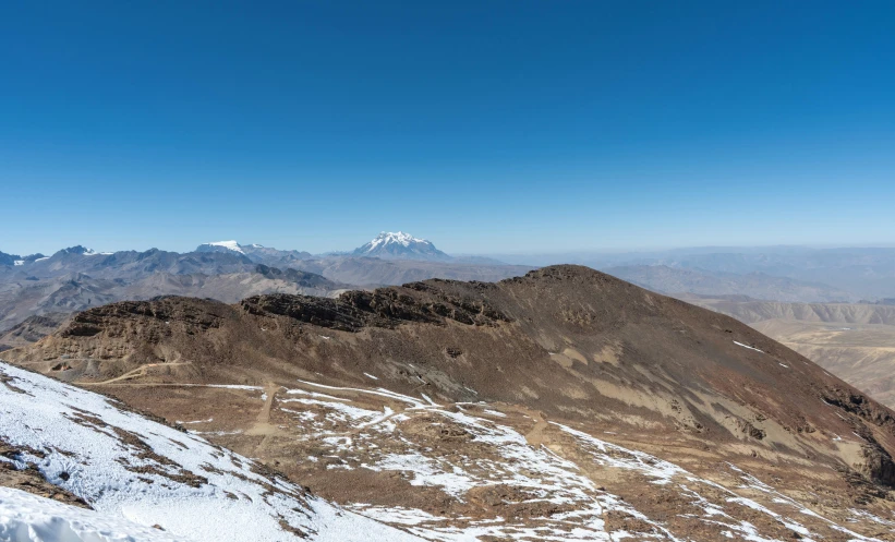 a snow covered mountain top with a sky background