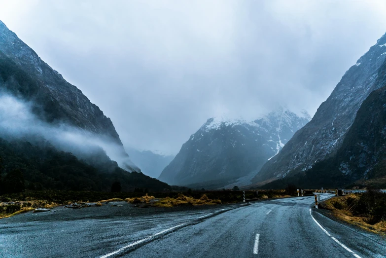 an open road with people walking across it