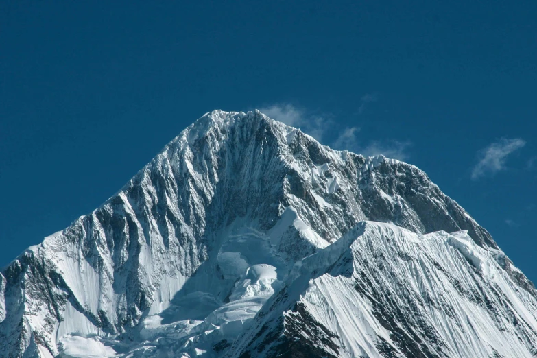 snow covered peak of a mountain in the middle of winter