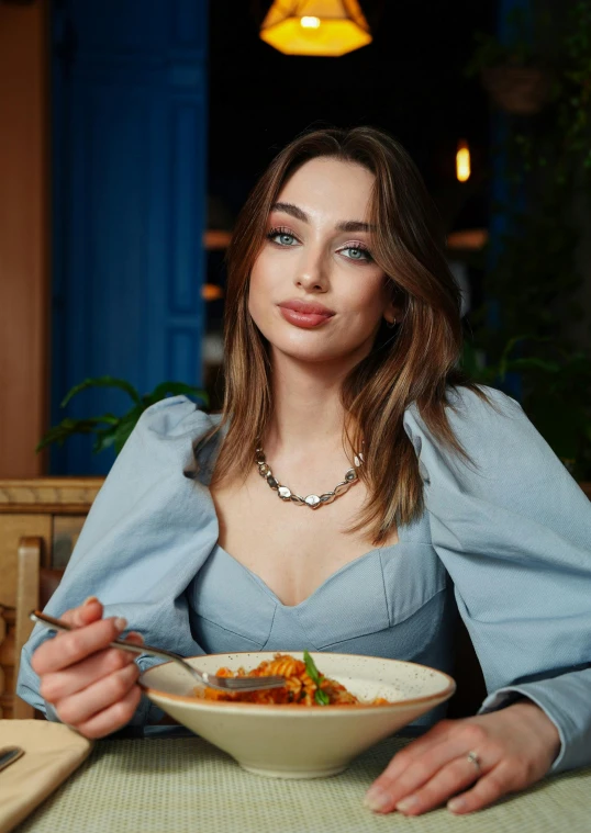 young woman holding a bowl of food on table