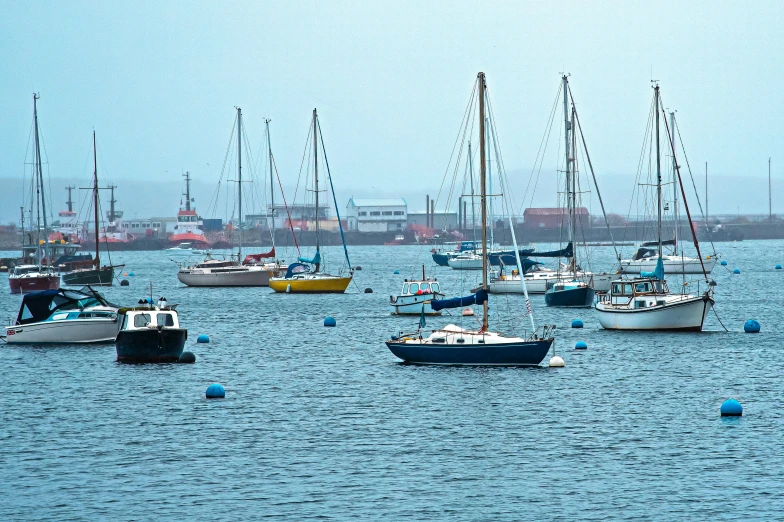 many boats in the water floating on top of each other