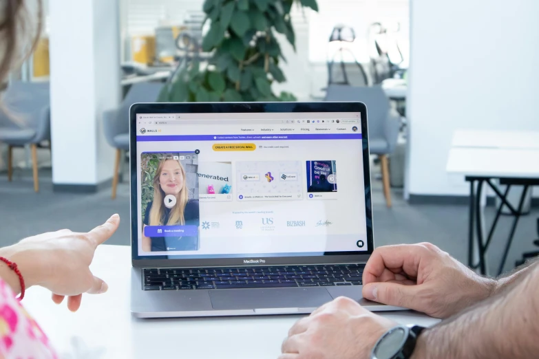 a man and woman are working on a laptop