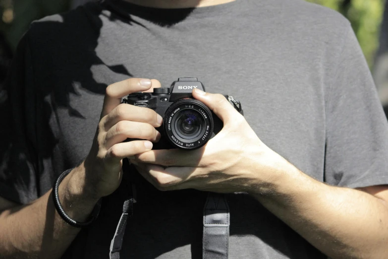 a man is holding up a camera and taking pos